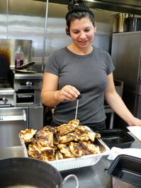 Shikes Haines - Stacy Williams checking grilled chicken at What's Cooking Ann Arbor
