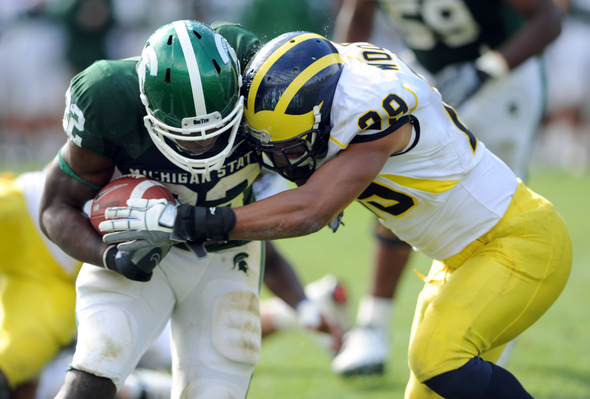 football players running. Michigan football player Troy