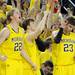 From left: Blake McLimans, Matt Vogrich, and Evan Smotrycz cheer from the bench after guard Stu Douglass made a three-pointer near the end of the 2nd half of the basketball game against Indiana. Michigan topped Indiana, 68 - 56. Angela J. Cesere | AnnArbor.com
