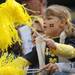 Belleville resident Amy Bradt holds onto her daughter, Alyssa Bradt, age 6, as she cheers for Michigan before the football game against EMU at Michigan Stadium on Saturday. Angela J. Cesere | AnnArbor.com