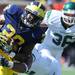 Michigan sophomore running back Fitzgerald Toussaint runs the ball while Eastern Michigan linebacker Marcus English tries to drag him down in the football game at Michigan Stadium on Saturday. Angela J. Cesere | AnnArbor.com