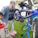 Word of God Community volunteer Phil Fleming, center, helps 5-year-old Ann Arbor resident Zubair Alam put air in his tire during the bike repair clinic held at the University Town Houses Co-op in Ann Arbor, Mich. on Saturday morning. The event, organized by B3, a community building organization, taught kids and parents about basic bike repair, gave away free helmets and held bike-related games.  Angela J. Cesere | AnnArbor.co