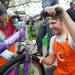  Common Cycle member Ben Schultz, right, helps 10-year-old Ann Arbor resident Nura Sukkar tighten her brakes. Angela J. Cesere | AnnArbor.com