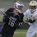 Pioneer's Peter Burke, left, tries to get past Holt's Cade Butch in overtime during the MHSAA lacrosse semi-finals game at Parker Stadium in Howell, Mich. on Wednesday evening. Angela J. Cesere | AnnArbor.com