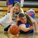 Lincoln Park's Ashley Majka, right, and Dexter's Riley McDonald dive for a loose ball. Angela J. Cesere | AnnArbor.com