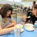 Skyline teacher Kayna Edwards, right, talks with 16-year-old Skyline special education student Natalie Wiliams while both enjoy pie from the Fall Feast.  AnnArbor.com | Angela J. Cesere
