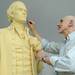 Sculptor Tony Frudakis smoothes out the urethane foam on Thomas Jefferson's chin.  Angela J. Cesere | AnnArbor.com
