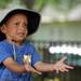 6-year-old Ann Arbor resident Brenden Flowers holds out his hand to catch a water balloon during the Juneteenth celebration at Wheeler Park. Angela J. Cesere | AnnArbor.com