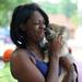 18-year-old Ann Arbor resident Keyshia Burton gets a kiss from Jackson, a 12-week-old puppy, during the 18th annual Juneteenth Celebration. Angela J. Cesere | AnnArbor.com