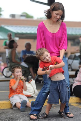 Ann Arbor resident Marie Doucet dances with her 2-year-old son, Ruben, during Nashbash at the Ann Arbor Farmer's Market on Thursday evening.  Angela J. Cesere | AnnArbor.com
