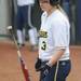 Michigan infielder Amanda Chidester tosses her bat while watching signals coming from head coach Carol Hutchins. Angela J. Cesere | AnnArbor.com
