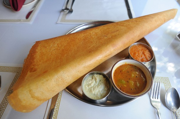Clockwise from top: a paper masala dosa with tomato chutney, sambar, and coconut chutney at Taste of India Suvai. Angela J. Cesere | AnnArbor.com