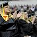 Washtenaw Community College graduate Dolly Jones claps during congressman John Dingell's speech during the WCC commencement ceremony held at Eastern Michigan University's Convocation Center on Saturday morning. Angela J. Cesere | AnnArbor.com