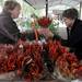 Pat Devulder, owner of Devulder Farm, left, hands a dried hot pepper bouquet to Brighton resident Mary Jane Monger. Angela J. Cesere | AnnArbor.com