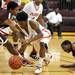 Willow Run's McKenzie Dunlap, center, struggles against River Rouge's Resean Coleman to maintain control of the ball. Angela J. Cesere | AnnArbor.com
