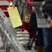 15-month-old Rosemarie Cassidy stands in line with her mother Sara as they wait to vote at Forsythe Middle School on Tuesday morning. Melanie Maxwell I AnnArbor.com