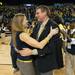 Wolverines Head coach Kim Barnes hugs the University of Michigan's Director of Athletics Dave Brandon after defeating Michigan State by one point. 
Courtney Sacco I AnnArbor.com 

