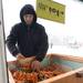 Mark Nowak fromm Seeley Farm lays out carrots during a snowy Saturday morning at the Ann Arbor Farmers Market in Kerrytown. 
 Courtney Sacco I AnnArbor.com 