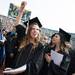 A graduate raises her fist in the air as Michigan's fight song is played before the start of the University of Michigan's spring commencement at Michigan stadium, Saturday May 4.
Courtney Sacco I AnnArbor.com    