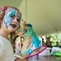 Seven-year-old Abby Plavnick shows her parents her face after having it panted by Body Masterpiece at the debut night of Top of the Park 2013 on Friday, June 15.
Courtney Sacco I AnnArbor.com 