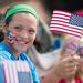 Marlys of Canton waves her American as she watches Ypsilanti's 4th of July parade travel down Cross Street.
Courtney Sacco I AnnArbor.com   