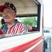 A man smiles as he drives a classic car down Cross Street as he takes part in Ypsilanti's 4th of July parade.
Courtney Sacco I AnnArbor.com 
