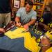 Former Michigan Wolverines Mike Martin, left, and Marcus Ray, right, sign autographs at the M Den in Ann Arbor on Wednesday, July, 10. 
Courtney Sacco I AnnArbor.com    