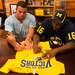 Former Michigan football players Marcus Ray and Mike Martin autograph a Michigan Wolverines T-shirt at the M Den on Wednesday, July, 10. 
Courtney Sacco I AnnArbor.com    