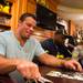 Former Michigan football players Mike Martin, left, and Marcus Ray, right, sign autographs at the M Den on Wednesday, July, 10. 
Courtney Sacco I AnnArbor.com    