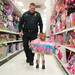 Having picked her self out a toy  three year old Lily Smith carries it down the aisle followed by Milan police Sargent Knieper during this years shop with a hero event at Meijer.
Courtney Sacco I AnnArbor.com 