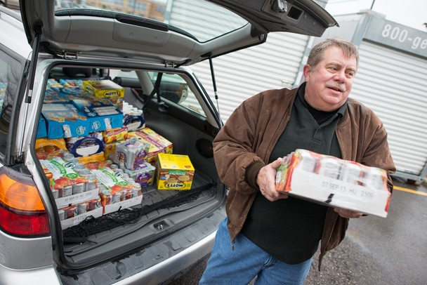 Warren Hughes helps unload canned goods to be donated to the 2012 Rockin' for the Hungry Food Drive. Courtney Sacco I AnnArbor.com