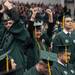 An undergraduate stands up to cheer as her school is called out during EMU's 2012 winter commencement.
Courtney Sacco I AnnArbor.com  