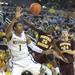Wolverines freshman Glenn Robinson III falls after being blocked by Central Michigan's Oivier Mbaigoto during their game Saturday Dec. 29. Courtney Sacco I AnnArbor.com  