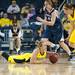 Wolverines Jenny Ryan passes the ball to Nicole Elmblad  as she lays on the ground during the second half of their game against the Lady Lions Monday, Jan. 21.

Courtney Sacco I AnnArbor.com 