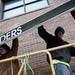 Laborers remove the awning from the building on Monday, Dec. 31. Daniel Brenner I AnnArbor.com