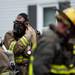 A firefighter removes him mask after exiting the structure on Heritage Drive on Tuesday. Daniel Brenner I AnnArbor.com