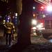 A firefighter carries equipment at the scene of a fire at 1310 Packard Street on Sunday, Jan. 13. Daniel Brenner I AnnArbor.com