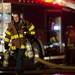 A firefighter carries equipment at the scene of a fire at 1310 Packard Street on Sunday, Jan. 13. Daniel Brenner I AnnArbor.com