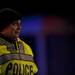 A police officer watches and contains the perimeter of a fire at 1310 Packard Street on Sunday, Jan. 13. Daniel Brenner I AnnArbor.com