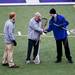 Head coaches  Jack Robenalt and Smith Altwood shake hands before the game on Friday, April 12. Skyline consultant Dr. James "Gil" Leaf presented the teams with a Native America lacrosse stick that will act as a traveling trophy for the two teams. AnnArbor.com I Daniel Brenner