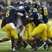 Michigan defensive tackle William Campbell and team tackles the Northwestern ball carrier in overtime on Saturday. Daniel Brenner I AnnArbor.com