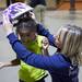 Melissa Cretsinger helps Miyami Thomas, 7, get her helmet lined up as the Ann Arbor Fire Department hosted its annual Bikes for Tykes event Tuesday December 13, 2011. The AAFD and Two Wheel Tango, a local bike shop, team up to provide bikes and helmets for children ages 4 to 10 who need assistance during the holiday season. Jeff Sainlar I AnnArbor.com