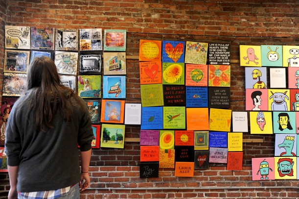 Saline resident Jeff Pando stares at the artwork of Sol Bermann at the 30x30 show at the Ann Arbor Art Center on Saturday afternoon. This is the center's 3rd annual event, where 30 artists each create 30 works in 30 days to benefit the Art for Kids program. Angela J. Cesere | AnnArbor.com