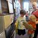 Valerie Newman-Taylor stands with her two kids Ingmar, age 5, center, and Soren, age 7, as they look at the artwork they picked out by artist Victoria Klein. Angela J. Cesere | AnnArbor.com
