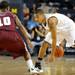Michigan guard Trey Burke, right looks for a path around Alabama A&M guard Jeremy Crutcher. Angela J. Cesere | AnnArbor.com