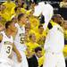 From right: guard Tim Hardaway Jr., forward Jordan Morgan and guard Trey Burke cheer after teammate Eso Akunne made a shot towards the end of the game. Angela J. Cesere | AnnArbor.com