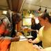 U-M Taubman College of Architecture faculty member Teman Evans, left, signs a form while Michigan Union Ticket Office employee Jennifer Mason hands him a ticket. Evans was the first person to receive a ticket to President Barack Obama's speech.  Angela J. Cesere | AnnArbor.com
