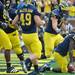 Michigan junior quarterback Denard Robinson kneels down in the end zone after a touchdown against SDSU at Michigan Stadium on Sept. 24, 2011. Angela J. Cesere | AnnArbor.com
