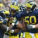 From right: senior offensive lineman David Molk and junior wide receiver Roy Roundtree congratulate junior running back Vincent Smith after his touchdown during the football game against San Diego State at Michigan Stadium on Sept. 24, 2011. Angela J. Cesere | AnnArbor.com