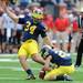 Michigan sophomore wide reciever Drew Dileo holds the ball for sophomore place kicker Brendan Gibbons during the football game against San Diego State at Michigan Stadium on Sept. 24, 2011. Angela J. Cesere | AnnArbor.com